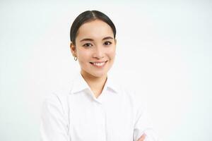 retrato de coreano mujer de negocios en camisa, sonrisas a cámara, concepto de corporativo personas y negocio, soportes terminado blanco antecedentes foto