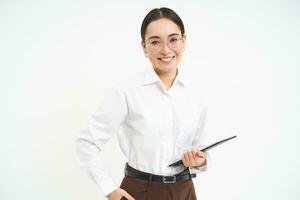 Asian woman professional, businesswoman in glasses, holding digital tablet, standing confident against white background photo