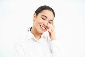 Successful women. Happy laughing asian woman smiling, looks carefree, stands over white studio background photo