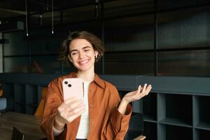 Young woman having a discussion over the phone, talking at smartphone, gesturing photo