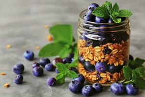 AI generated a blueberry yogurt and granola parfait in a jar with mint leaves photo