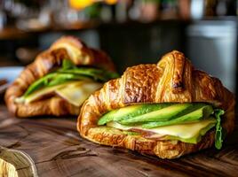 AI generated two croissant sandwiches with avocado and cheese on top photo