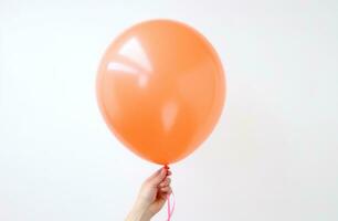 AI generated person holding on to orange balloon party. photo