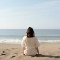 AI generated the back of a woman sitting on the beach, photo