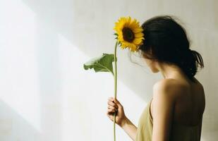 AI generated woman holding a sunflower in front of a white wall, photo