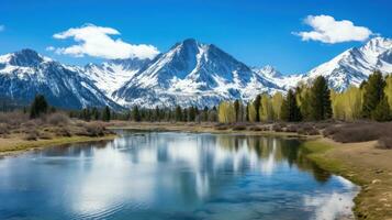 AI generated A serene mountain range with snow-capped peaks, a clear blue sky, and a tranquil lake in the foreground. photo