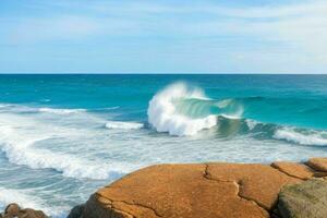 AI generated Sea waves hitting rocks on a beautiful beach. Pro Photo