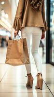 ai generado espalda ver de moderno comprador con compras bolsa de papel caminando en el centro comercial bokeh difuminar antecedentes foto