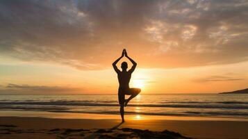 AI generated A man doing yoga on a beach, with the ocean and sunrise in the background photo