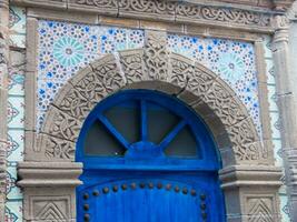 a blue door with decorative tiles on the side photo