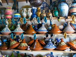 a shelf with many vases and pots on it photo