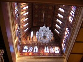 a chandelier hanging from a ceiling in a building photo