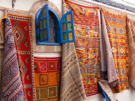 a wall with colorful rugs photo