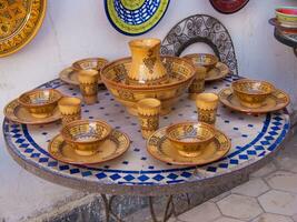 a table with a bowl and cups on it photo