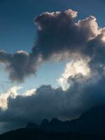 a plane flying in the sky with a cloud in the background photo