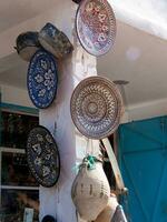a wall with many plates hanging from it photo