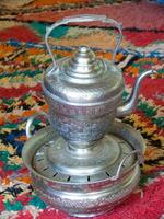 a silver tea pot on a table photo