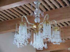 a chandelier with a gold frame and crystal balls photo