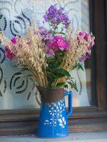 a blue vase with flowers photo