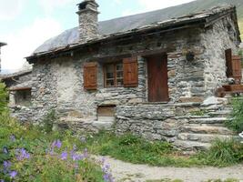 stone house with wooden shutters photo