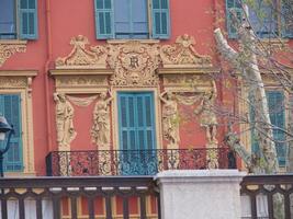 a red building with green shutters photo