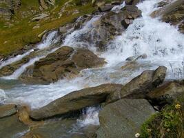 water flowing over rocks photo