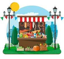 Traditional market wooden food stall full of food with flags, crates. City park, street lamp and trees. Sky with clouds and sun. Fair, grocery and shopping. Vector illustration flat style