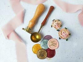 Colorful wax seal stamps and wax bead on a white background photo