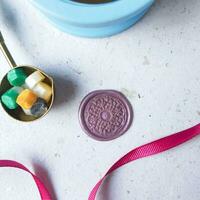 top view of colorful wax bead and wax coin on the table photo