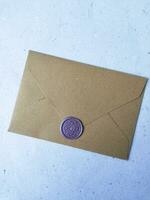 Envelope with wax seal on a white background, top view photo