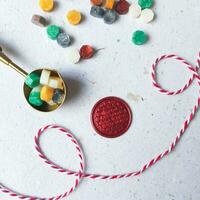 wax coin and colorful wax bead on white background with copy space. top view. photo