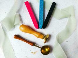 Colorful wax seal stamps and wax bead on a white background photo