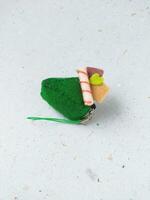 a closeup shot of handmade felt woolen toy on a white background. Selective focus. photo