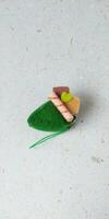 a closeup shot of handmade felt woolen toy on a white background. Selective focus. photo