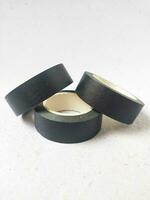 black paper washi tape roll with adhesive tape isolated on white background photo