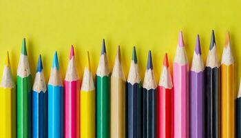 AI generated A row of colored pencils on a yellow background photo