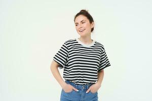 Image of young confident woman in casual outfit, looking happy, standing against white background photo