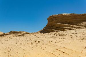 desert landscape, layered sandstone rock photo