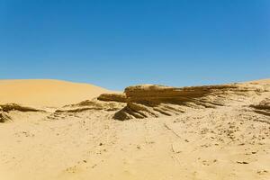 desert landscape, layered deposits in the sandy desert photo
