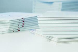 stacks of freshly printed photobooks on the table close-up photo