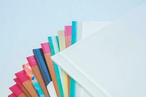 multi-colored spines of photo books close-up, partial blur