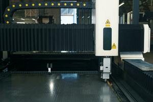 industrial laser cutting machine during metal sheet processing photo