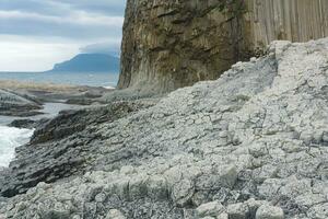Columnar basalt rock, Cape Stolbchaty on Kunashir Island, in the foreground bases of lava basalt columns form a kind of pavement photo