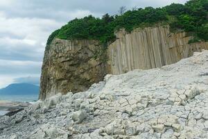 Columnar basalt rock, Cape Stolbchaty on Kunashir Island, in the foreground bases of lava basalt columns form a kind of pavement photo