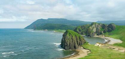 aerial view of the beautiful coastline of Kunashir island with basalt cliffs photo