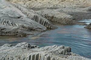 coastal seascape with beautiful columnar basalt rocks at low tide photo