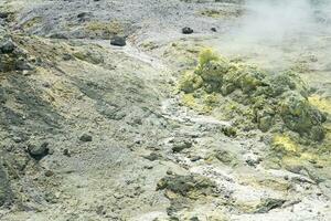 tephra soil with yellow deposits of sulfur minerals in the area of volcanic gases in the solfataric field photo