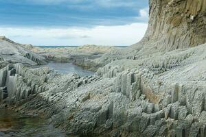 coastal seascape with beautiful columnar basalt rocks at low tide photo