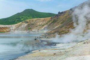hot mineralized lake with thermal spring and smoking fumaroles in the caldera of the Golovnin volcano on the island of Kunashir photo
