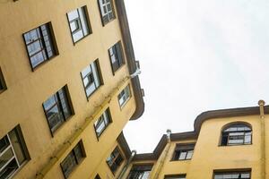 view of the upper floors of vintage buildings from the narrow and deep courtyard-well photo